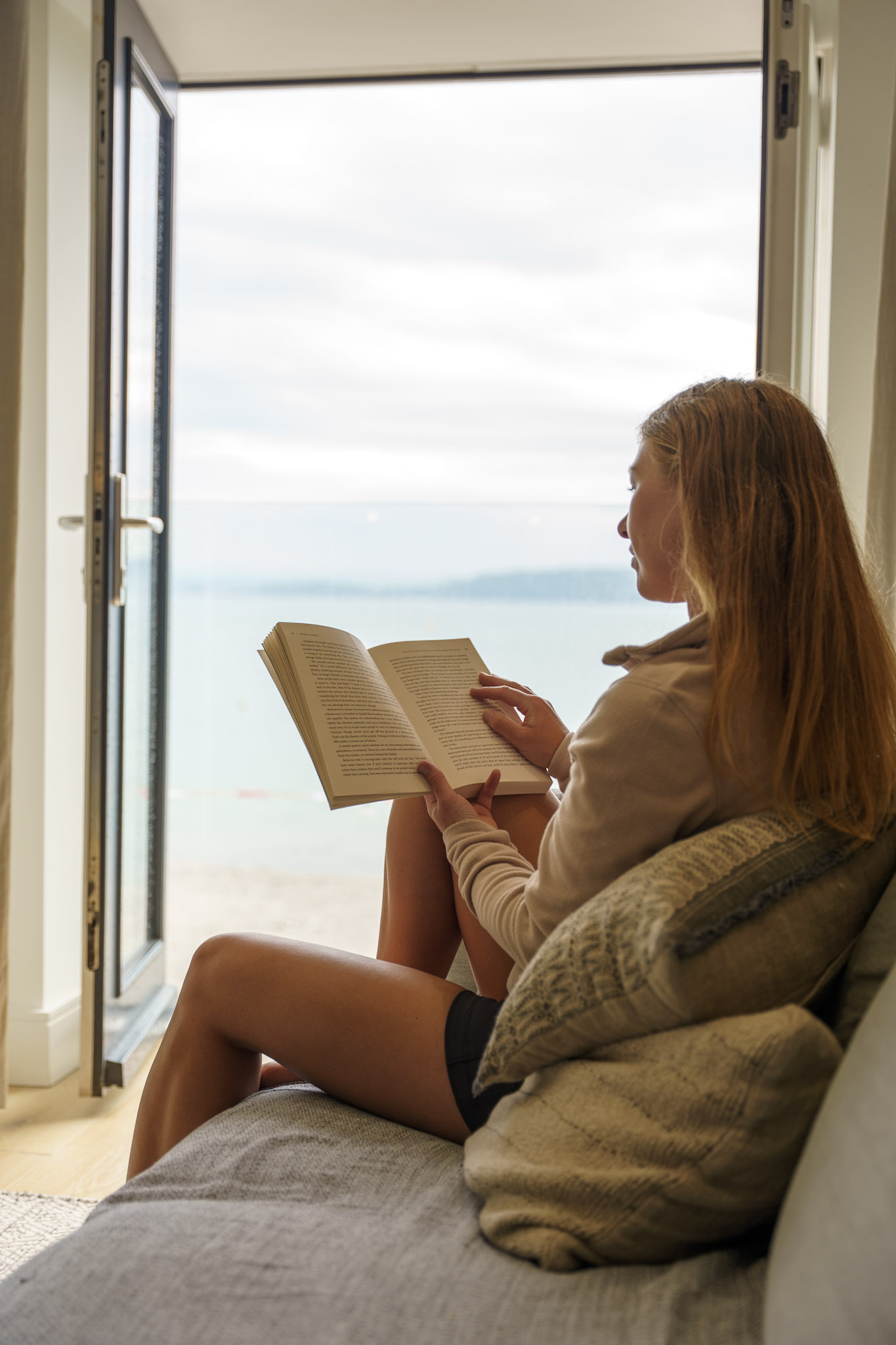 Me reading a book with views over the ocean